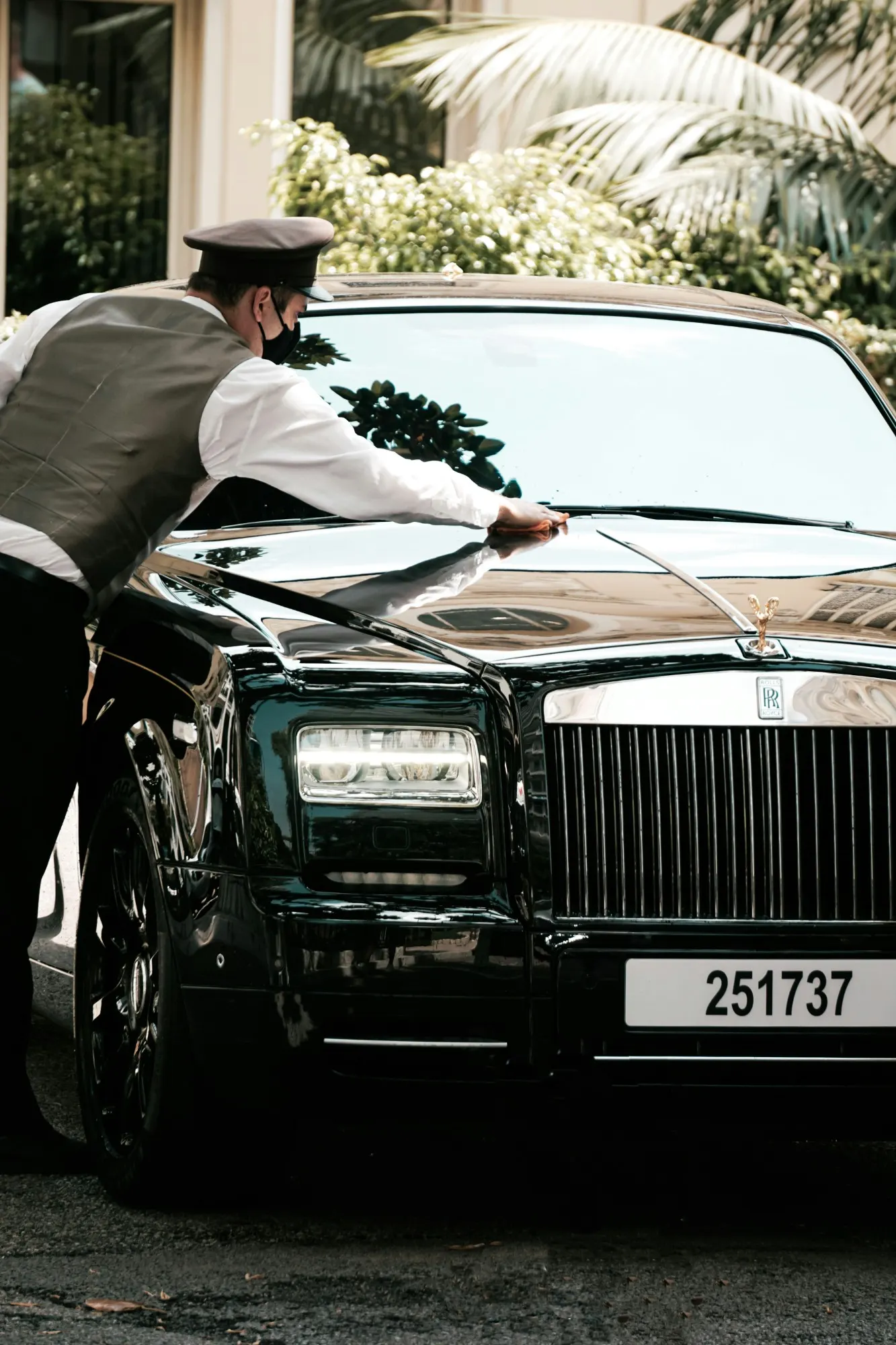 A chauffeur preparing a luxury saloon before a corporate assignment