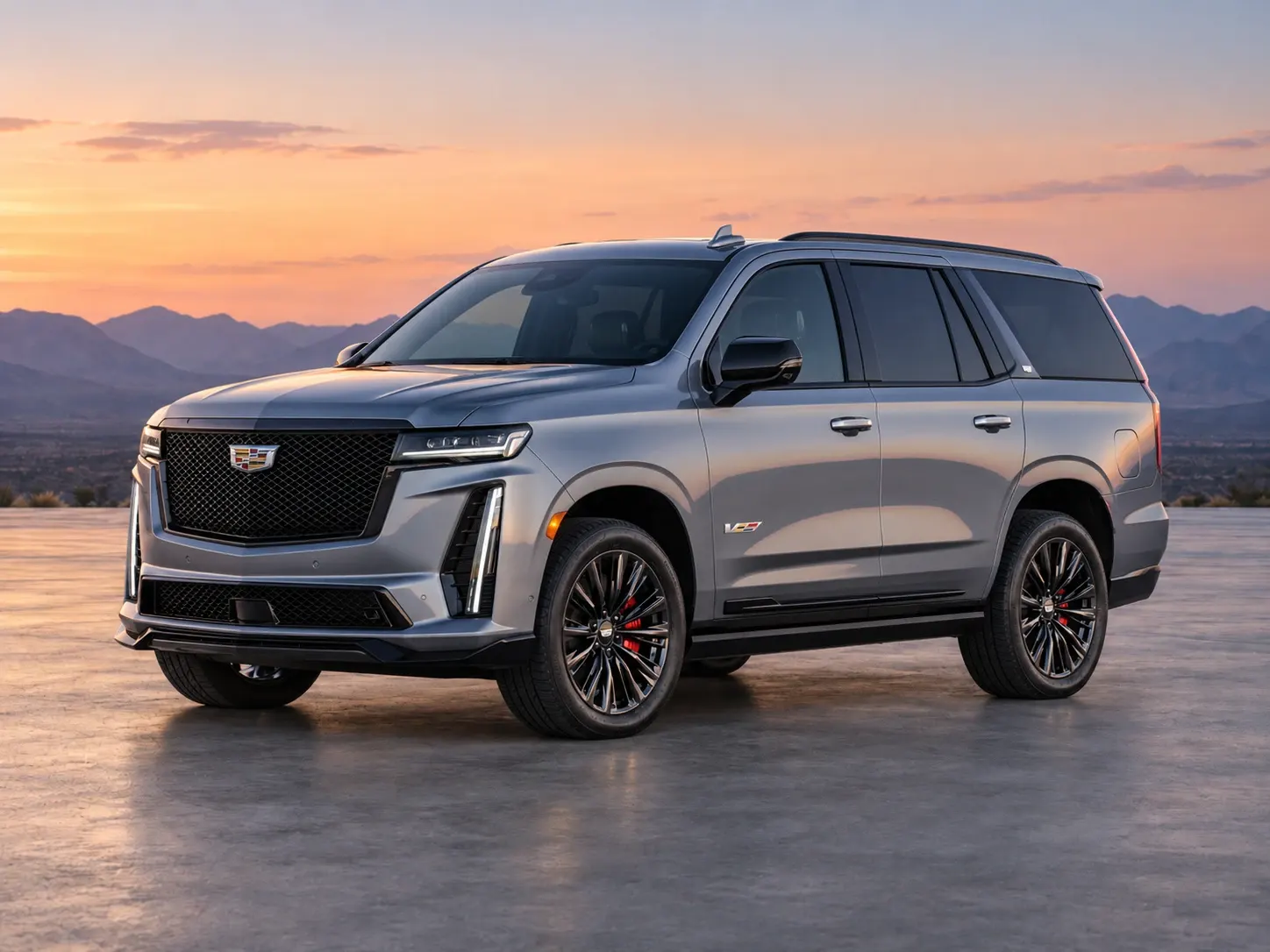 A silver Cadillac Escalade full-size luxury SUV, front three-quarter view